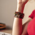 A woman& x27;s hand with Bracelets from jasper and obsidian and tiger eye stones. Royalty Free Stock Photo