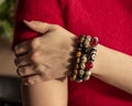 A woman& x27;s hand with Bracelets from jasper and obsidian and tiger eye stones. Royalty Free Stock Photo