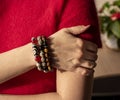 A woman& x27;s hand with Bracelets from jasper and obsidian and tiger eye stones. Royalty Free Stock Photo