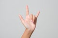 Woman& x27;s hand giving the Rock and Roll sign, devil horns gesture Royalty Free Stock Photo