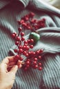 Woman& x27;s hand holding red Christmas tree decoration, minimalistic color scheme, lots of texture. Royalty Free Stock Photo