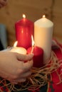 Hand lighting a set of colored candles Royalty Free Stock Photo