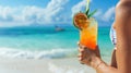 A woman& x27;s hand holds a cold iced tea or a tropical cocktail made from fresh papaya fruit on a beach exotic vacation Royalty Free Stock Photo