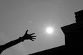 woman& x27;s hand reaching for the sun with silhouette of modern buil Royalty Free Stock Photo