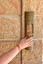 A woman& x27;s hand with a red thread touches the mezuzah at the entrance to the area near Royalty Free Stock Photo