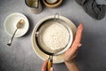 Woman& x27;s hand sifting flour through sieve. Baking, cooking, pastry concept. Top view. Royalty Free Stock Photo