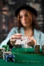 woman& x27;s hand takes poker chips and cards from a pile at a round poker table. risky bets in poker Royalty Free Stock Photo