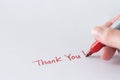 Hand writing thank you note using red marker pen Royalty Free Stock Photo