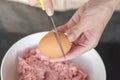 A womans hands beat an egg into meat, close-up. The process of cooking meat. Royalty Free Stock Photo