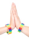 Woman's hands with a bracelet patterned as the rainbow flag. isolated on white Royalty Free Stock Photo