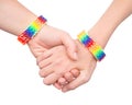 Woman's hands with a bracelet patterned as the rainbow flag. on white. Royalty Free Stock Photo