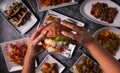 Woman& x27;s hands holding tasty american burger and french fries at restaurant table. Flat lay. Top view Royalty Free Stock Photo