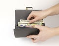 The woman& x27;s hands are holding a wallet with money. Dollars and euros in the purse. The concept of the standard of Royalty Free Stock Photo