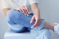 Woman& x27;s hands with perfect manicure wears in denim trousers and white basic t-shirt.