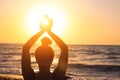 Woman's hands symbolizing prayer and gratitude. Mudra. Yoga concept. Silhouette of female hands on sun background Royalty Free Stock Photo