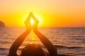 Woman's hands symbolizing prayer and gratitude. Mudra. Yoga concept. Silhouette of female hands on sun background Royalty Free Stock Photo