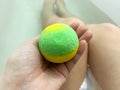 woman& x27;s legs and hands holding bath bomb in a tub, self care concept Royalty Free Stock Photo