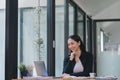 Woman& x27;s portrait in the office while working and researching ideas using a laptop. Happy businesswoman searches Royalty Free Stock Photo