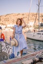 Woman yacht sea. A young happy woman in a blue dress and hat sta