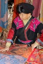 Woman of the Red Yao hill tribe sells hand woven shawls, Dazhai / Longsheng, China