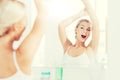 Woman yawning in front of mirror at bathroom Royalty Free Stock Photo