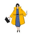 Woman in a yellow coat with black bob and black bag. Autumn and winter look.