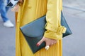 Woman with yellow coat, green leather bag and ring with pearls before Luisa Beccaria fashion