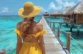 Woman in yellow dress and hat standing on pier with ocean view Royalty Free Stock Photo