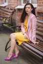 Woman in yellow dress and pink blazer Royalty Free Stock Photo