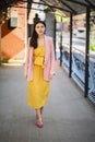 Woman in yellow dress and pink blazer Royalty Free Stock Photo