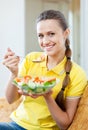 Woman in yellow eating vegetables salad Royalty Free Stock Photo