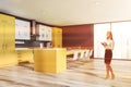 Woman in yellow and gray kitchen with table Royalty Free Stock Photo