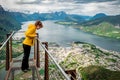 Woman in yellow jacket looking on Andalsnes city from rampestreken Royalty Free Stock Photo