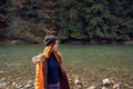 woman in yellow jacket on nature travel river autumn