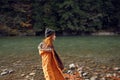 woman in yellow jacket on nature travel river autumn