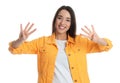 Woman in yellow jacket showing number eight with her hands on white background Royalty Free Stock Photo