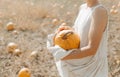 Woman yellow pumpkin holds hands subject Halloween