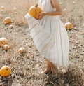 Woman yellow pumpkin holds hands subject Halloween