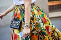 Woman with yellow, red and orange floral skirt, jewel bag and Rolex Datejust before Versace fashion show, Milan Royalty Free Stock Photo