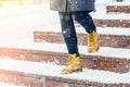 A woman in yellow shoes goes down the stairs Royalty Free Stock Photo