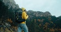Backpacker tourist stand on mountain landscape at autumn travel on cloudy day