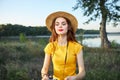 Woman in yellow t-shirt hat red lips photographer nature fresh air