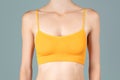 Woman in yellow top bra on gray background Royalty Free Stock Photo