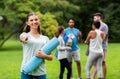 Woman with yoga mat pointing finger to camera Royalty Free Stock Photo