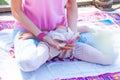 Woman in yoga meditation position  outdoor spring summer day close up of lower body hands  hold magnolia flower Royalty Free Stock Photo