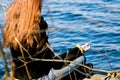 Woman at yoga pose at the lake