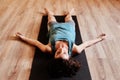 Woman, yoga and sleeping on floor for rest, peace and mindfulness in gym, fitness studio or class. Girl, meditation and