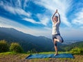 Woman in yoga Vrikshasana tree pose outdoors