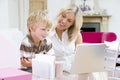 Woman and young boy in home office with laptop Royalty Free Stock Photo