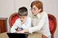 Woman and young boy with laptop Royalty Free Stock Photo